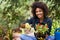 Shes got a green thumb. Portrait of a happy young woman and her tray of plants for the garden.