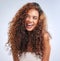 Shes got some haircare ideas...an attractive young woman posing in studio against a grey background.