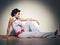 Shes got some serious style. Full-length studio shot of a stylishly dressed young woman sitting on the floor.