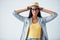 Shes highly self-aware. Studio shot of a beautiful young woman wearing a hat against a white background.