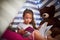 Shes a keen reader. a little girl reading a book with her teddybear in a tent at home.