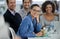 Shes leading them in the right direction. Businesswoman smiling at the camera with her colleagues at a meeting table.