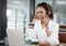 Shes more than willing to help. an attractive young female call center agent working at her desk in the office.