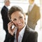 Shes never too busy for her clients. a businesswoman making a call with her colleagues in the background.