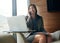 Shes never too busy to make that call. a businesswoman using her laptop in the office while answering a phonecall.