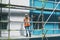 Shes not afraid to delegate and command. a young woman talking on a cellphone while working at a construction site.