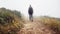 Shes one determined hiker. Rear view of a female hiker walking along a hiking trail.