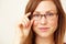 Shes one smart cookie. Cropped portrait of a beautiful young redhead wearing glasses.