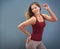 Shes always positive. a carefree young woman posing against a gray background.