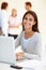 Shes positive its going to get done. Shot of an attractive young woman using a laptop in a brightly lit office.