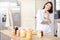 Shes proud of her domestic skills. A mature woman holding a jar to her chest in the kitchen.