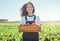 Shes proud of her produce. a female farmer holding a crate of freshly harvested tomatoes.