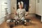 Shes a rock star in the making. a little girl playing drums on a set of pots in the kitchen.