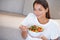 Shes really savoring that salad...an attractive young woman enjoying a fresh salad.