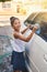 Shes scrubbing till its squeaky clean. Portrait of a young girl busy cleaning a car outside.