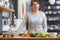 Shes a serious foodie. Portrait of an attractive woman standing behind a kitchen counter filled with vegetables.