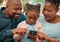 Shes teaching us everything we need to know. a little girl using a phone with her grandparents at home.