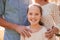 Shes their pride and joy. A cropped portrait of a happy young girl standing outdoors with her parents.