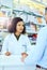 Shes there to help. an attractive young female pharmacist helping a male customer in the pharmacy.