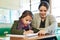 Shes always there to help her learners. an elementary school girl getting help from her teacher in class.