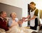 Shes there to help whenever shes needed. a nurse assisting and elderly patient and her husband in their room.