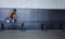 Shes thinking about running away. Full length shot of a young woman looking depressed while sitting on a bench in a