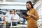 Shes working wirelessly. Cropped portrait of an attractive young businesswoman in the office with his colleagues in the