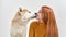Shiba Inu dog licking face of young european woman