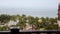 A shifting focus view from a hotel looking out onto palm trees and the ocean during a storm near Cancun, Mexico.