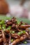 Shimeji mushroom served with chives on black stone plate. Typical oriental meal. Detail of food dish, closeup, selective focus