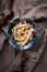Shimeji mushrooms in a bowl on grey chef`s apron background. Pickled japanese brown beech or buna shimeji. Umami taste. Vegetarian