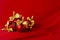 Shimmer glitter glossy red balls with gold bows on deep scarlet silky smooth wavy background, copy space. Luxury New year.