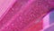 Shimmering background glitter sand pink paint wave