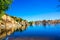 Shimmering Waters Around Rock Shoreline Of Lake In Foothills