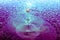 Shimmery Purple and Blue Water with A Milky White Droplet in Motion