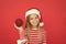 Shine and glitter. Child Santa Claus costume hat. Happy smiling face. Beautiful detail. Positivity concept. Cheerful