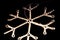 Shine golden snowflake with glitter isolated on black background,snowflake light Christmas decoration close up down view full fram