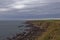 Shingle Beaches, rocky outcrops and Red Sandstone Cliffs with Farmland seen from the Angus Coastal Footpath.