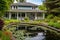 shingle style house with veranda and a pond in the backyard