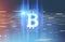 Shining bitcoin sign, blue red background