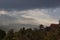 Shining dramatic Indonesian landscape with rainy sky, heavy clouds, sunbeams and haze over tropical valley after rain.