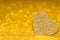 Shining heart on a golden radiant background. Glitter shine with 3d shape