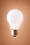 Shining lightbulb isolated on the beige background