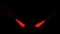 The shining red eyes of the evil beast on the black screen.