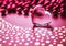 Shining transparent heart and a group of red beads. Perfect Valentine`s Day greeting card background. Horizontal image in pink