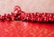 Shining transparent heart and a group of red beads. Perfect Valentines Day greeting card background