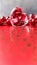 Shining transparent heart and a group of red beads. Perfect Valentines Day greeting card background. Vertical image in red tone