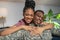 Shining woman hugging man in military uniform