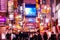 Shinjuku at night vibrant busy street night life with many lightbox signs - Tokyo