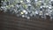Shiny aluminium round billets fall from conveyor belt closeup.